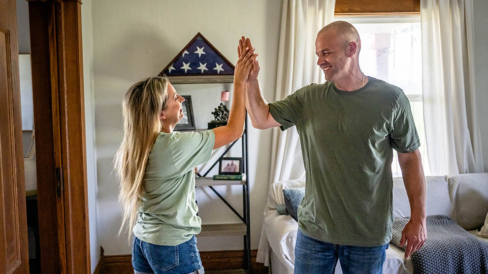 Couple high-fiving in living room